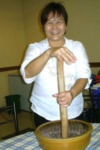 Amy Wong shows the bowl and stick she uses to make pounded tea.