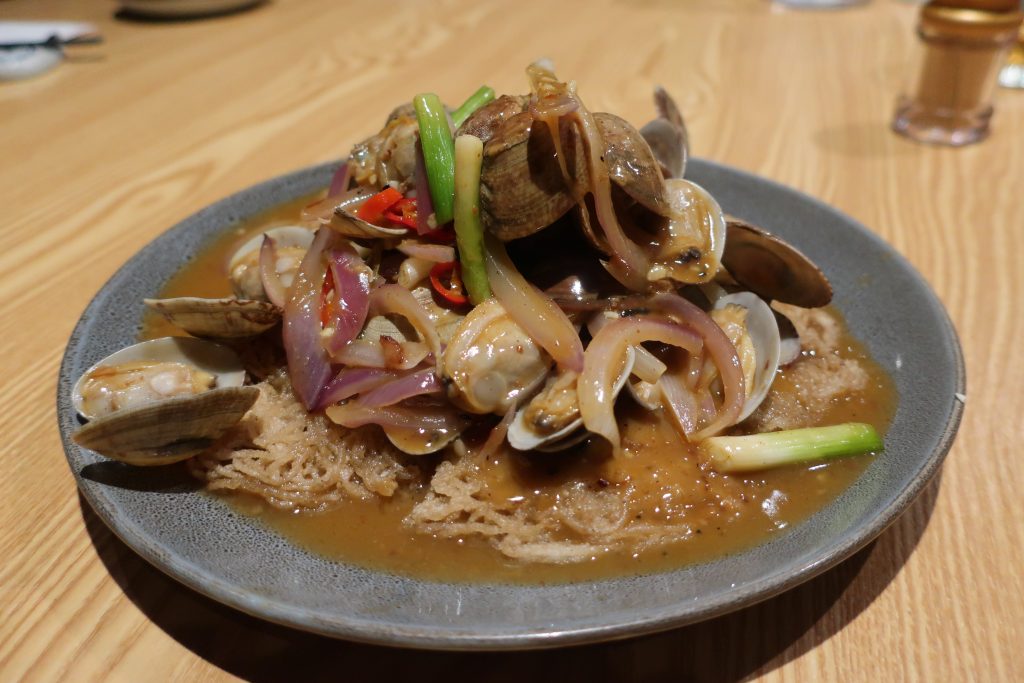 Hakka-style clams on a bed of pan-fried noodle coils