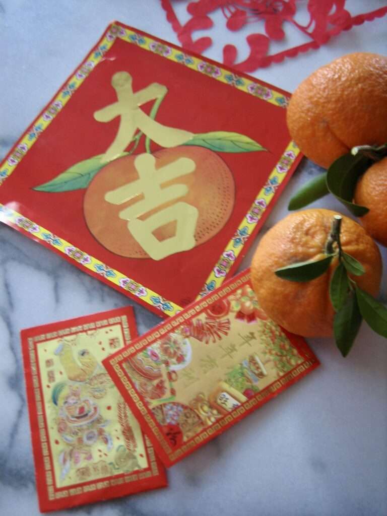 Symbols of Chinese New Year: red envelopes, tangerines, good luck banners