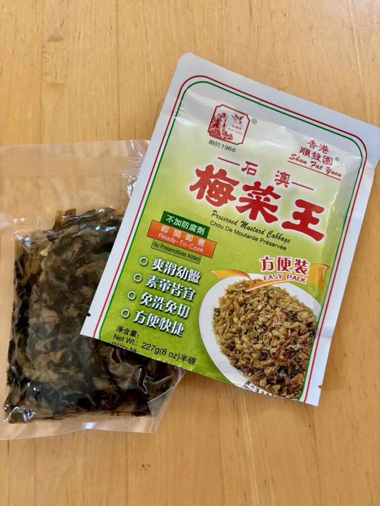 Look for Easy Pack Preserved Mustard Cabbage by Shun Yuen Fat (Stone Crane) in the preserved or dried vegetable section of Asian supermarkets